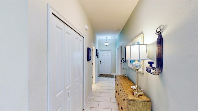 hallway featuring light tile patterned flooring