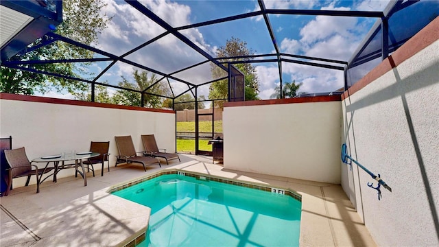 view of swimming pool featuring glass enclosure and a patio