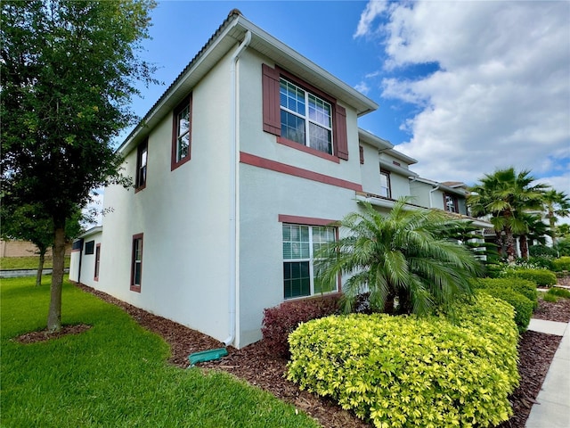 view of side of home featuring a yard