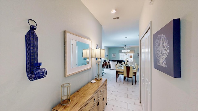 hall featuring light tile patterned floors