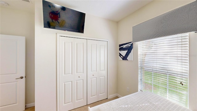 bedroom with carpet and a closet