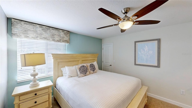 bedroom featuring ceiling fan and light carpet