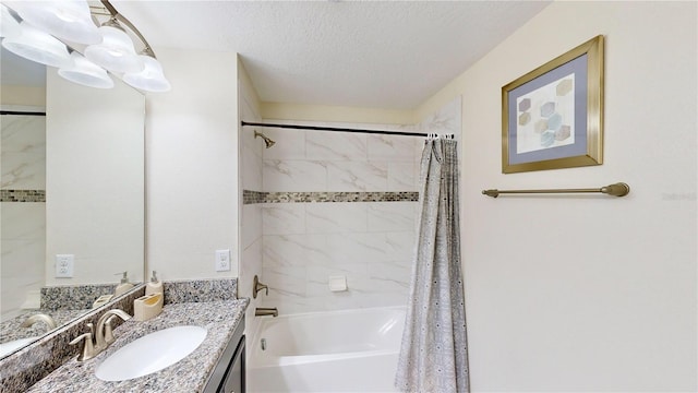 bathroom with vanity, shower / bath combination with curtain, and a textured ceiling