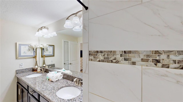 bathroom with a textured ceiling and vanity