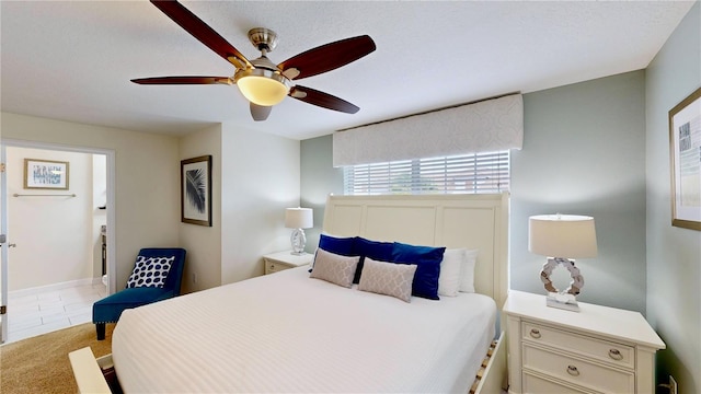 bedroom with ceiling fan and light carpet