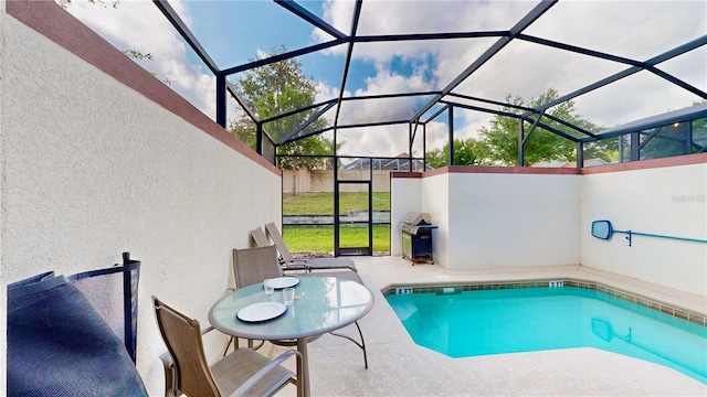 view of pool with area for grilling, a lanai, and a patio