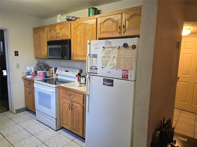 kitchen with light tile patterned floors and white appliances