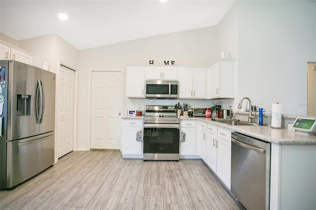 kitchen with white cabinets, sink, appliances with stainless steel finishes, and tasteful backsplash