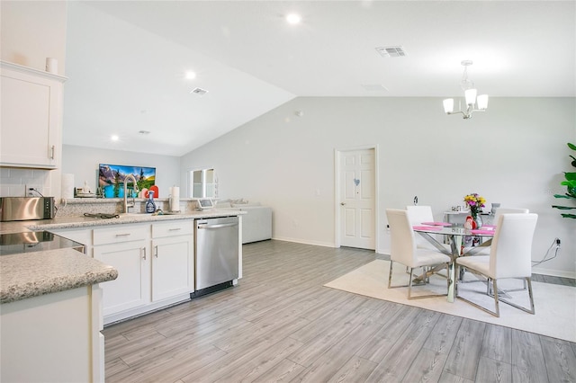 kitchen with white cabinetry, pendant lighting, stainless steel dishwasher, and light hardwood / wood-style flooring