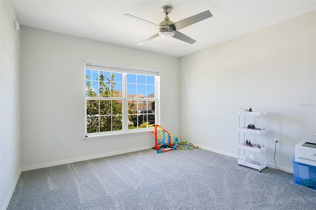 rec room with carpet and ceiling fan