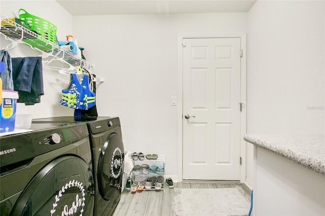 washroom featuring light hardwood / wood-style floors and washing machine and clothes dryer