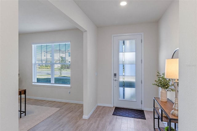 foyer featuring light wood finished floors and baseboards