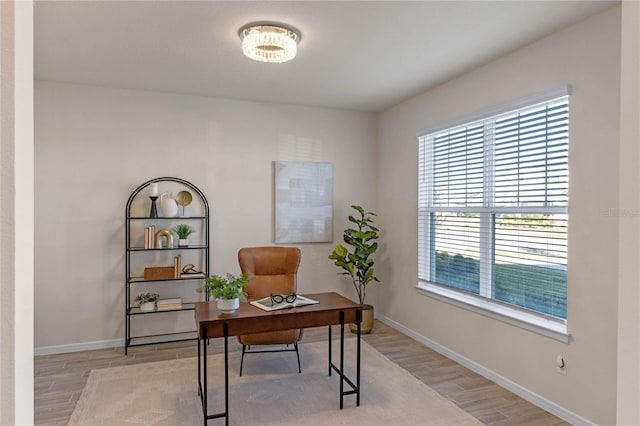 office space with light wood finished floors and baseboards