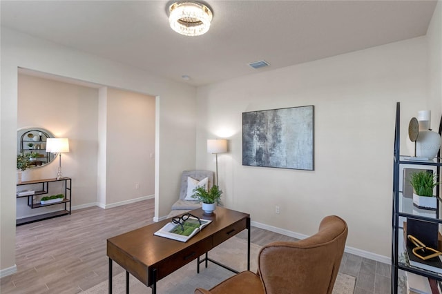 interior space featuring light wood finished floors, baseboards, and visible vents