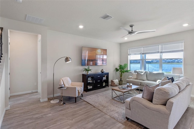 living room with recessed lighting, visible vents, a ceiling fan, light wood-type flooring, and baseboards