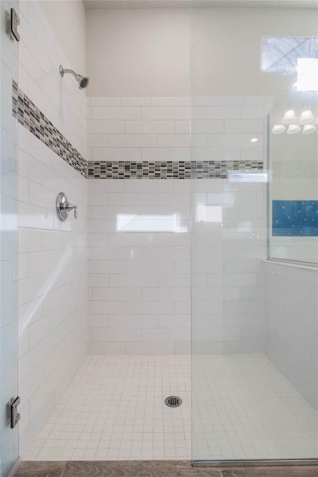 full bath with a shower stall