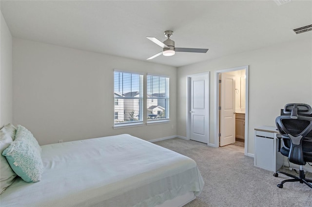 bedroom featuring baseboards, visible vents, a ceiling fan, light colored carpet, and ensuite bathroom