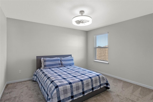 bedroom featuring carpet and baseboards