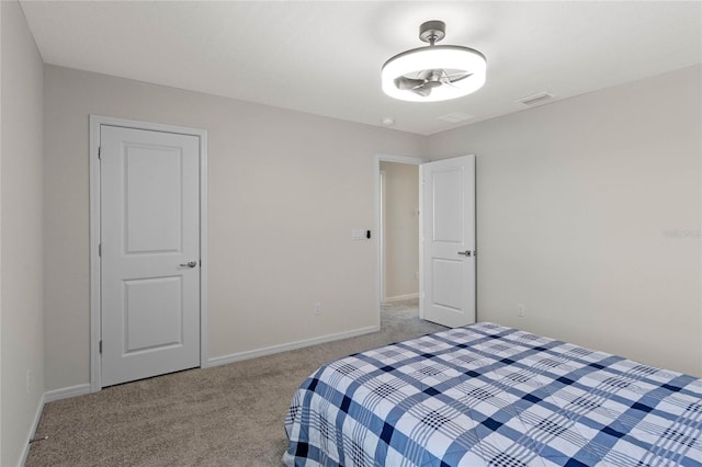 bedroom featuring light carpet and baseboards