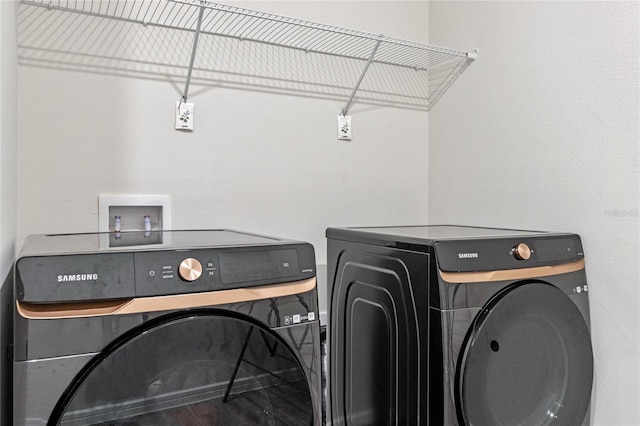 laundry area featuring laundry area, independent washer and dryer, and wood finished floors