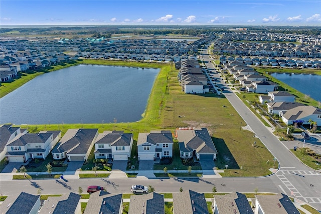 drone / aerial view featuring a residential view and a water view