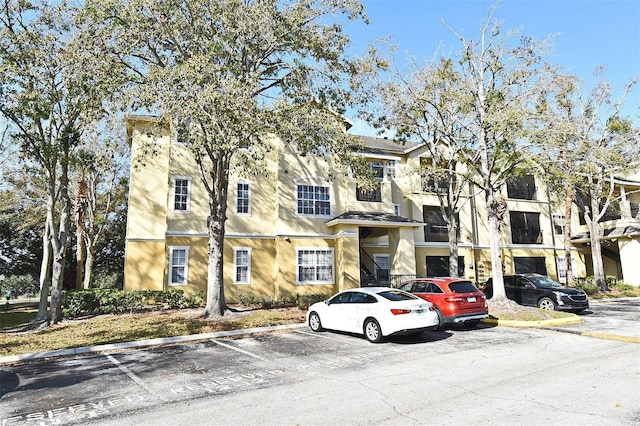 2572 Robert Trent Jones Dr Unit 1231, Orlando, FL 32835 - view of building exterior with uncovered parking