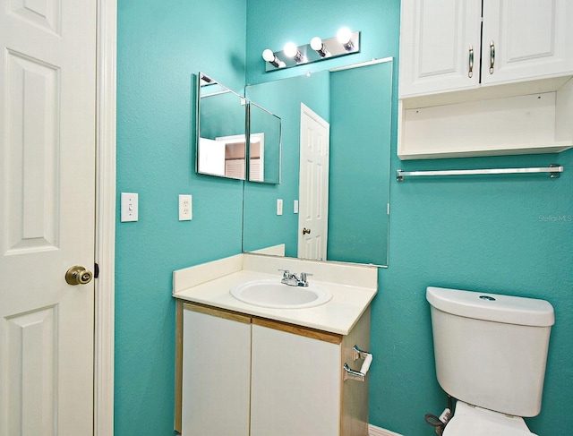 2572 Robert Trent Jones Dr Unit 1231, Orlando, FL 32835 - half bathroom with toilet, a textured wall, and vanity