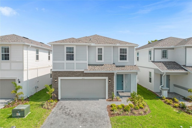 view of front of home featuring a garage and a front yard