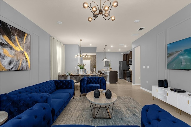 living room featuring light tile patterned flooring and an inviting chandelier