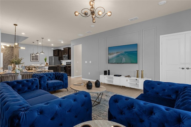 tiled living room with a notable chandelier