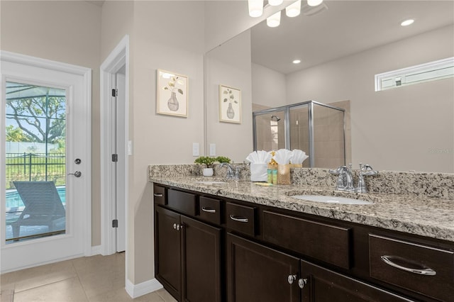 bathroom with tile patterned flooring, vanity, and a shower with shower door