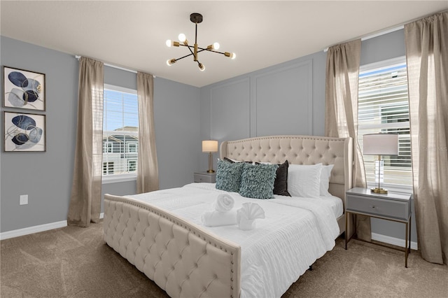 bedroom featuring carpet flooring and an inviting chandelier