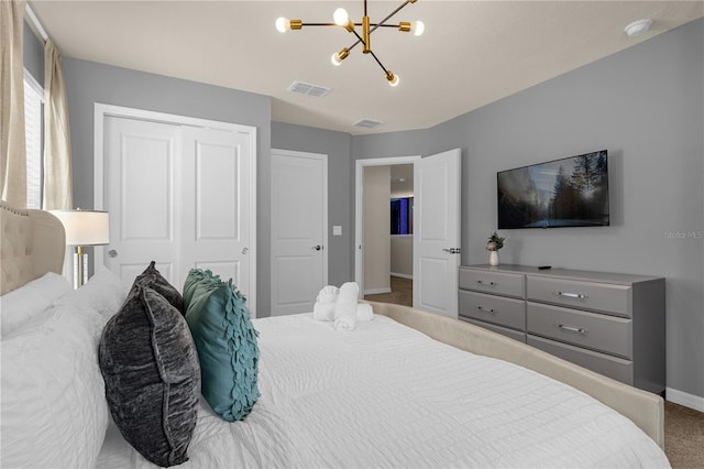 bedroom featuring a chandelier, carpet floors, and a closet