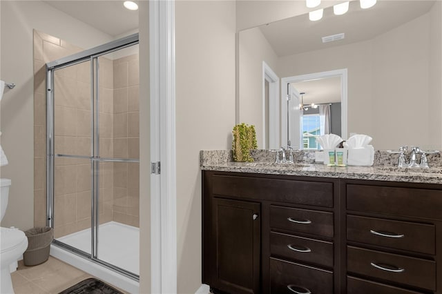 bathroom with walk in shower, tile patterned floors, vanity, and toilet