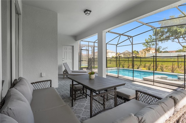 exterior space featuring a fenced in pool, glass enclosure, and an outdoor living space