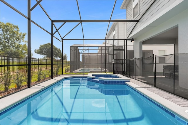 view of swimming pool with glass enclosure and an in ground hot tub