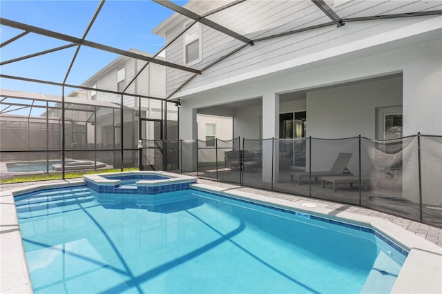 view of swimming pool with glass enclosure, an in ground hot tub, and a patio