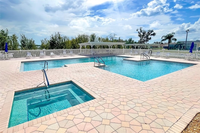 view of pool featuring a patio area and a community hot tub