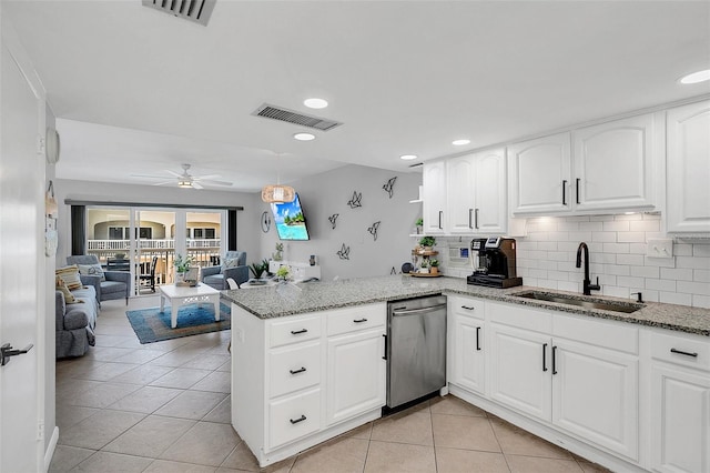 kitchen featuring dishwasher, kitchen peninsula, white cabinets, and sink