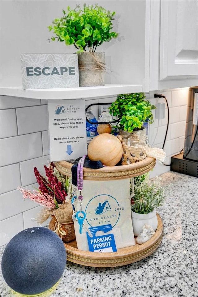 details with white cabinets and tasteful backsplash