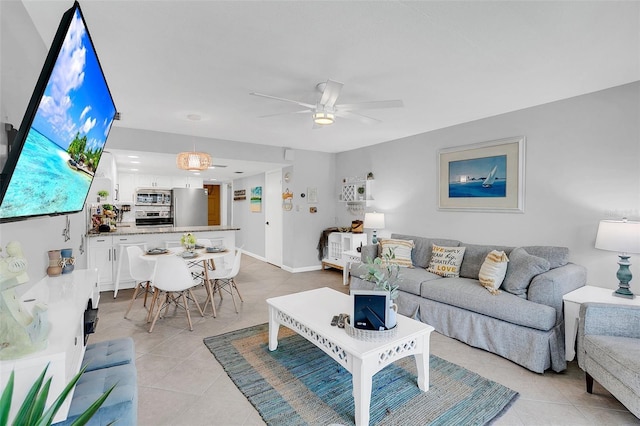 living room with ceiling fan and light tile patterned floors