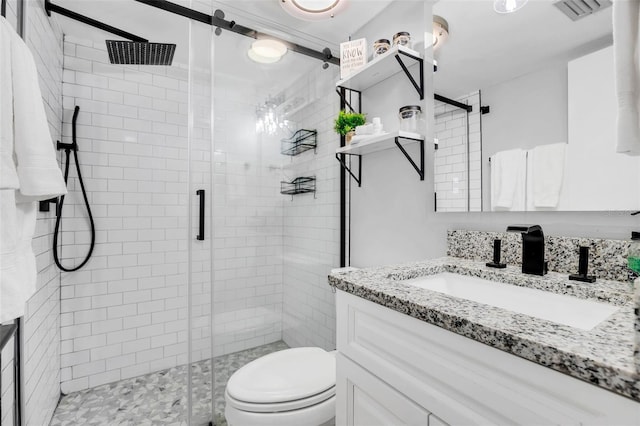 bathroom featuring walk in shower, vanity, and toilet