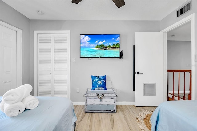 bedroom with light hardwood / wood-style flooring and ceiling fan