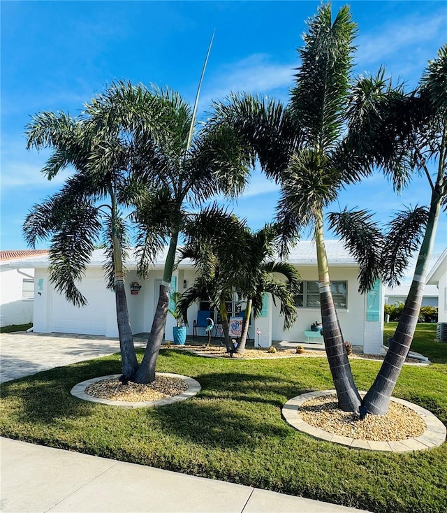 view of front of property with a garage and a front yard