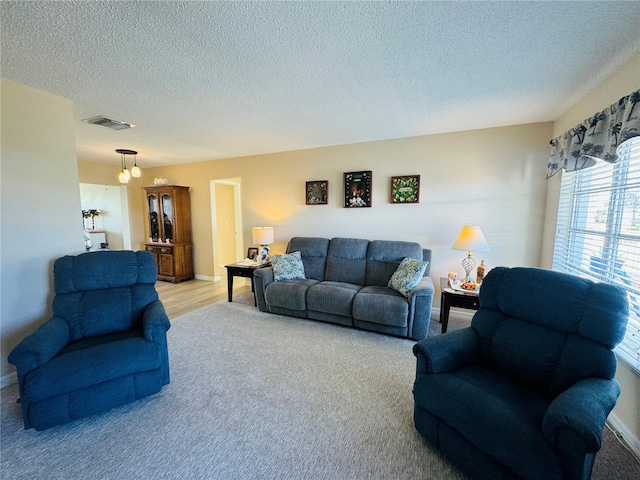 living room with light colored carpet and a textured ceiling