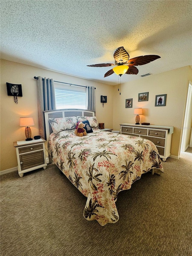 carpeted bedroom with ceiling fan and a textured ceiling