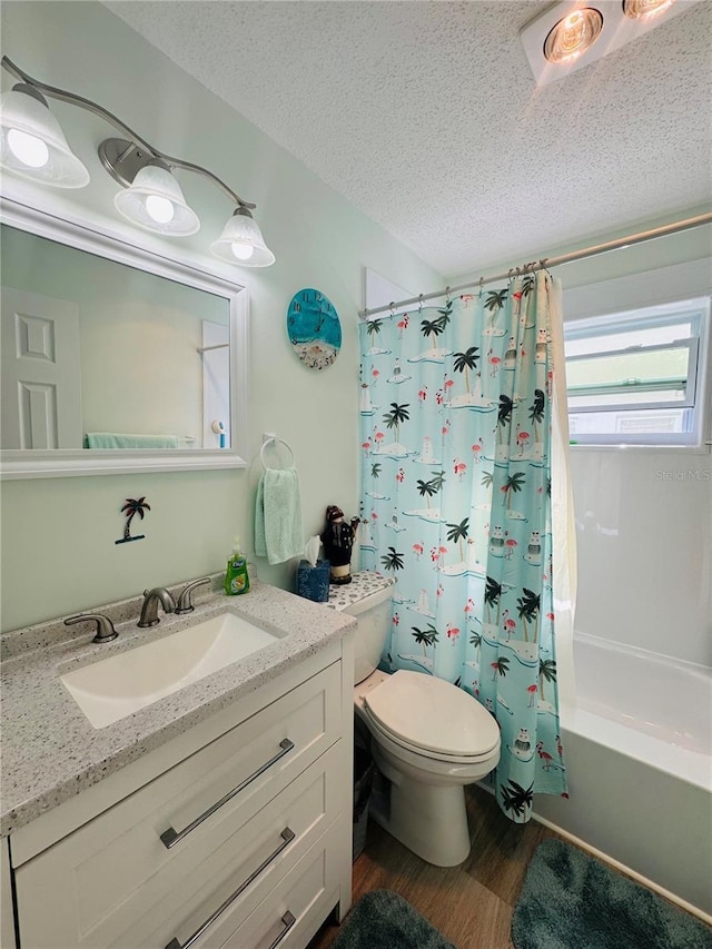 full bathroom featuring hardwood / wood-style flooring, vanity, a textured ceiling, toilet, and shower / bath combo with shower curtain