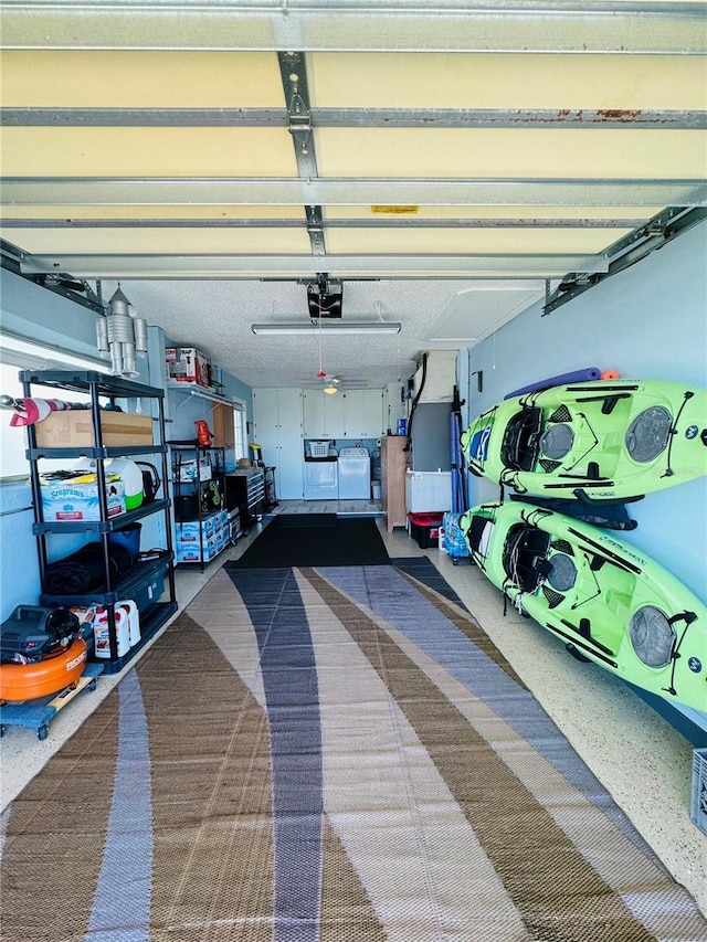 garage with a garage door opener and washer and clothes dryer