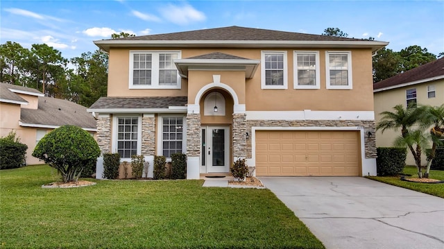 view of front of property featuring stone siding, stucco siding, driveway, and a front yard