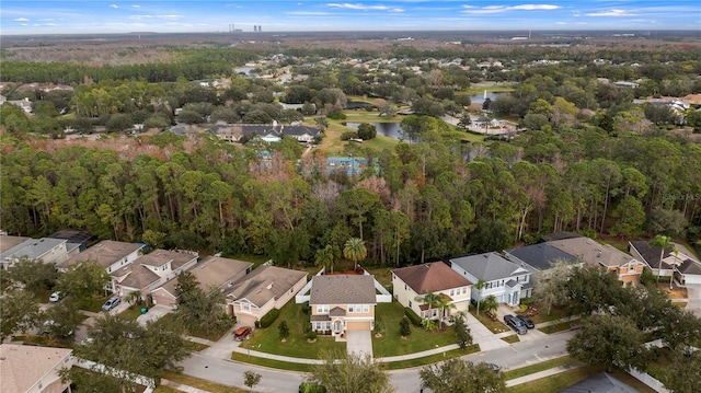 aerial view featuring a residential view and a wooded view